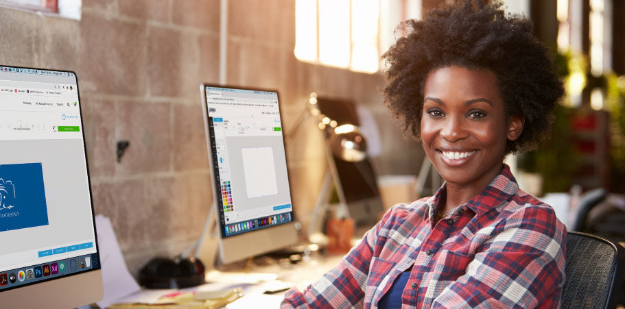 Graphic designer sitting behind her desk and smiling